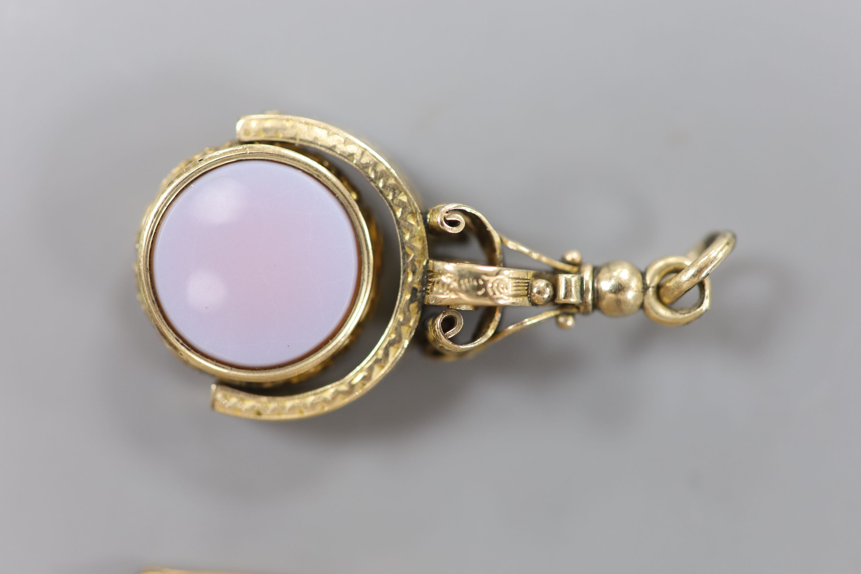 A Victorian yellow metal overlaid, bloodstone and sardonyx set swivelling fob seal, 42mm and a 9ct, peridot and seed pearl set bar brooch, 40mm.